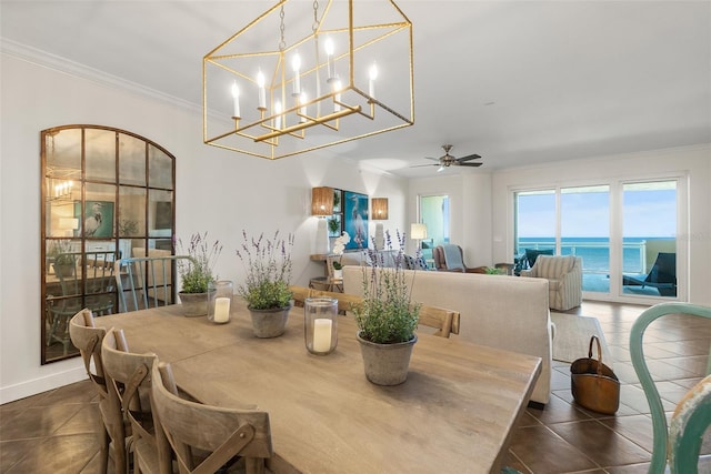 dining area featuring a water view, ceiling fan, and ornamental molding