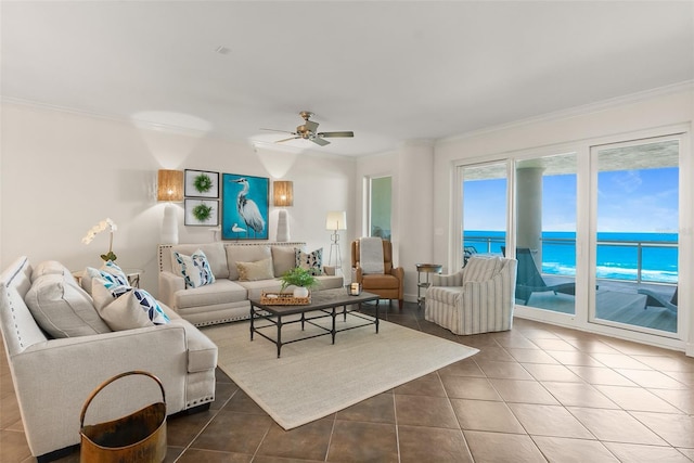 living room with ceiling fan, tile patterned flooring, a water view, and ornamental molding