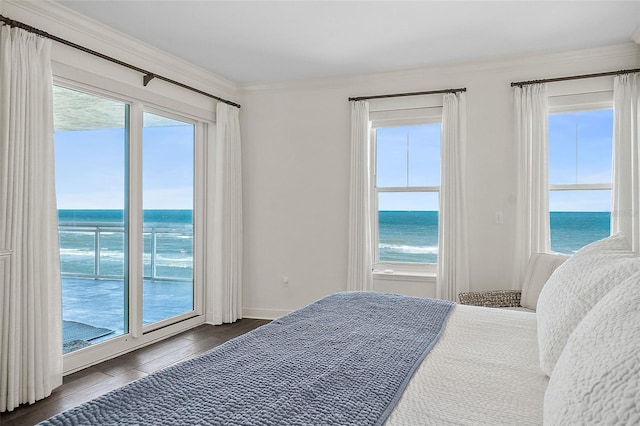 bedroom featuring dark hardwood / wood-style flooring, a water view, ornamental molding, and access to outside