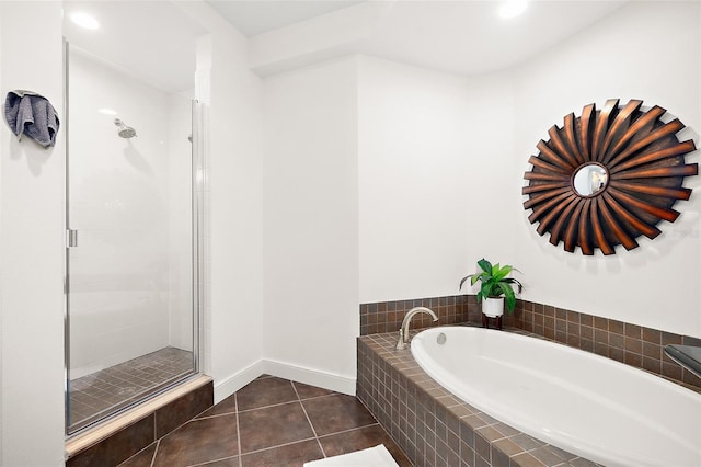 bathroom with tile patterned flooring and separate shower and tub