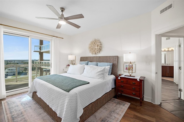 bedroom featuring access to exterior, ceiling fan, ensuite bathroom, and dark wood-type flooring