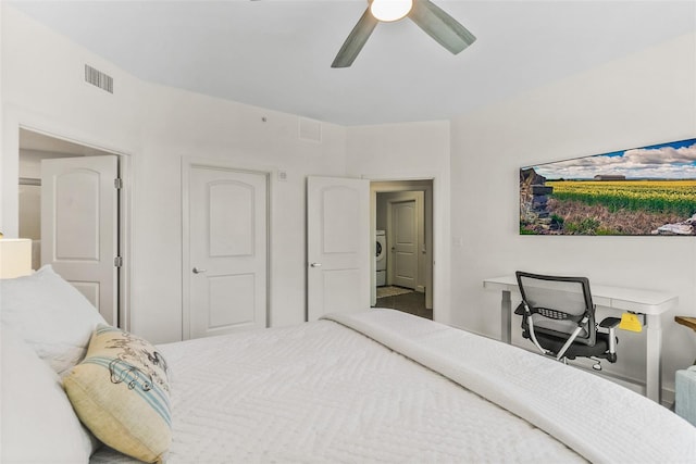 bedroom featuring ceiling fan and washer / dryer