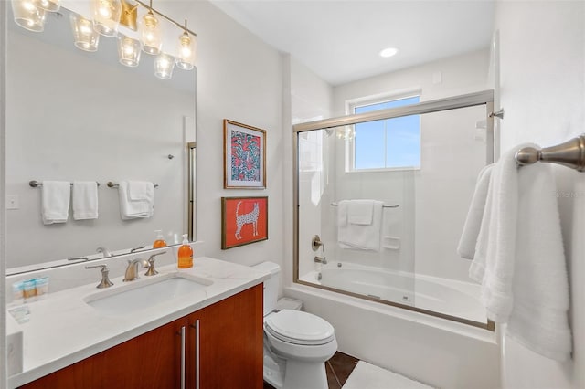 full bathroom with tile patterned floors, vanity, combined bath / shower with glass door, and toilet