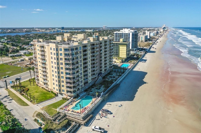 drone / aerial view with a water view and a beach view