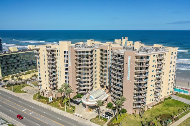 view of property featuring a water view and a view of the beach