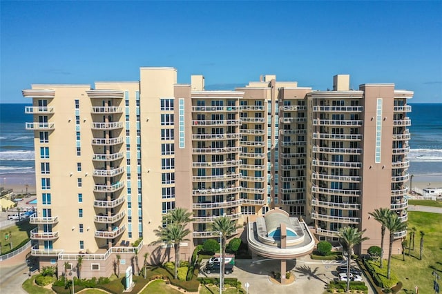 view of property with a beach view and a water view