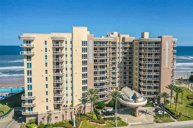 view of property featuring a water view and a view of the beach