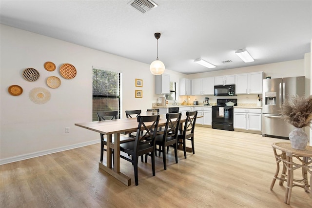 dining area featuring light wood-type flooring