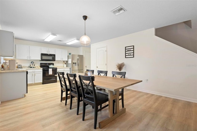 dining space with light wood-type flooring