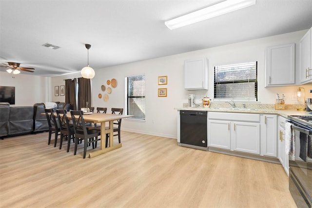 kitchen featuring hanging light fixtures, sink, white cabinets, and black appliances