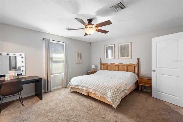 bedroom with carpet flooring, a textured ceiling, and ceiling fan