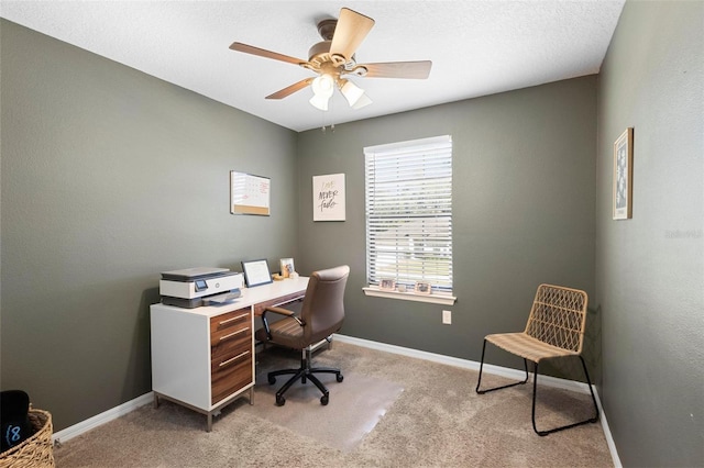 carpeted office space with ceiling fan