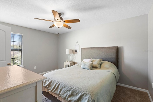 bedroom featuring ceiling fan, carpet floors, and a textured ceiling