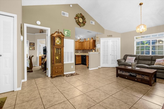 living room featuring a chandelier, light tile patterned floors, and high vaulted ceiling