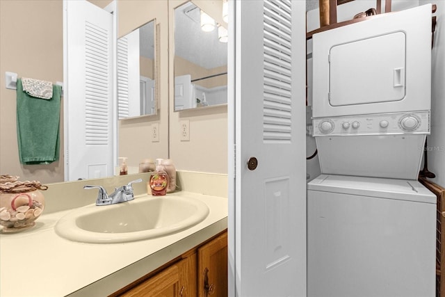 bathroom with vanity and stacked washer / dryer