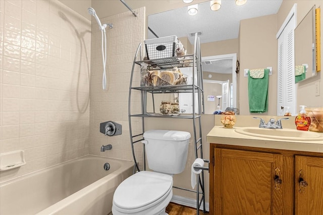 full bathroom featuring vanity,  shower combination, toilet, and a textured ceiling