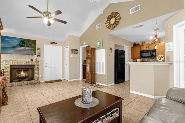 living room with ceiling fan, light tile patterned floors, high vaulted ceiling, and a brick fireplace