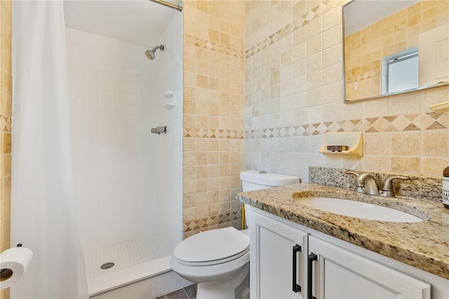 bathroom featuring toilet, walk in shower, tile patterned flooring, tile walls, and vanity