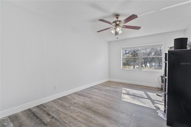 interior space with ceiling fan and light hardwood / wood-style floors