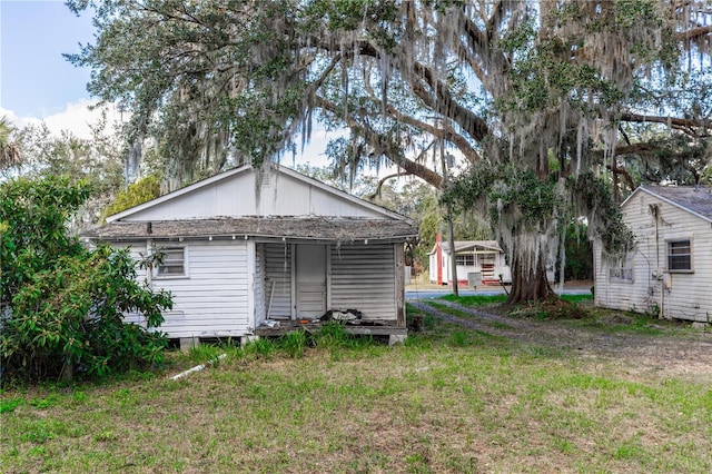 back of property with a lawn