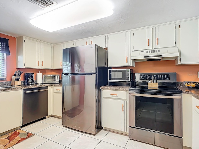 kitchen with light tile patterned floors, white cabinetry, and appliances with stainless steel finishes