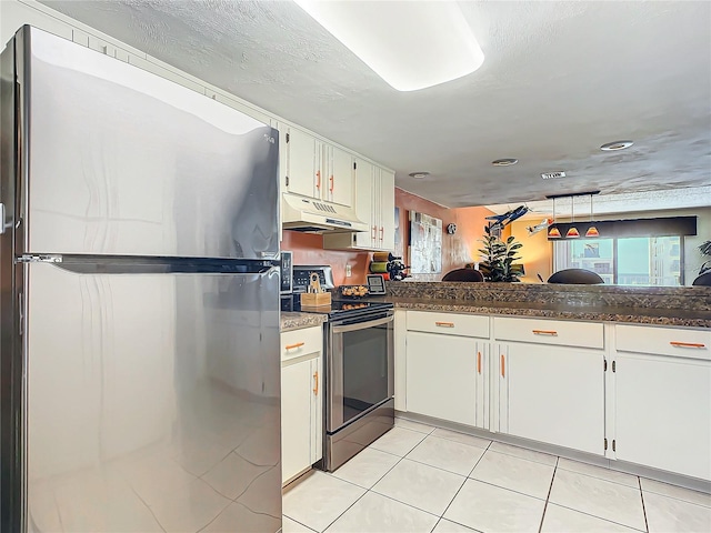 kitchen featuring light tile patterned flooring, kitchen peninsula, white cabinets, and stainless steel appliances