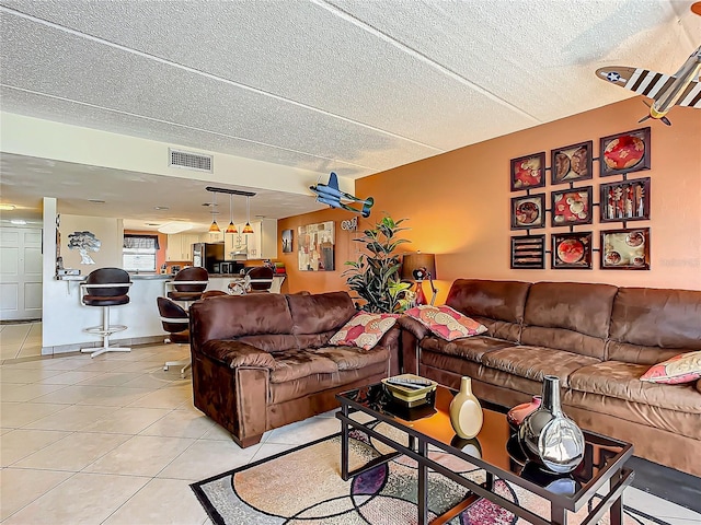 tiled living room with a textured ceiling