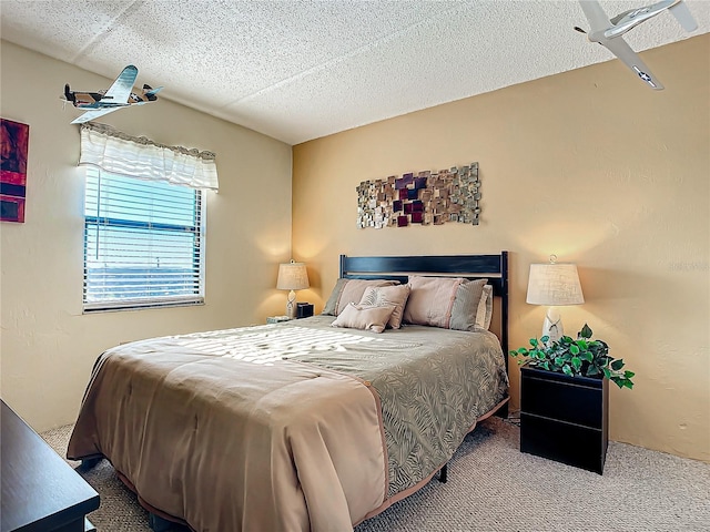 bedroom with carpet and a textured ceiling