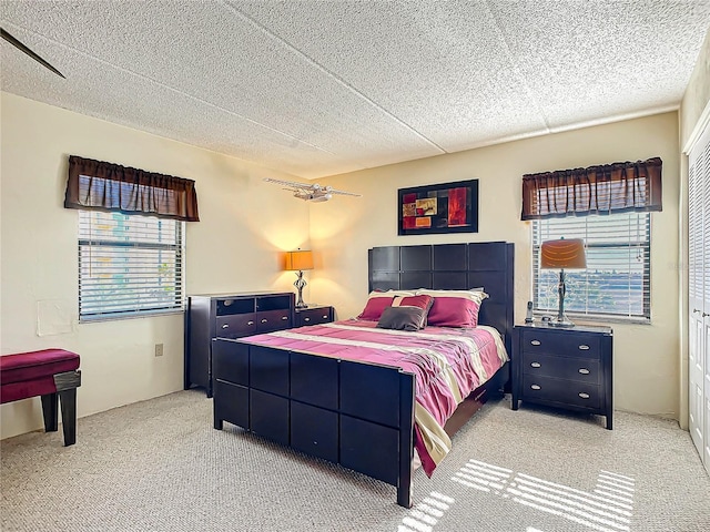 bedroom featuring light carpet and ceiling fan