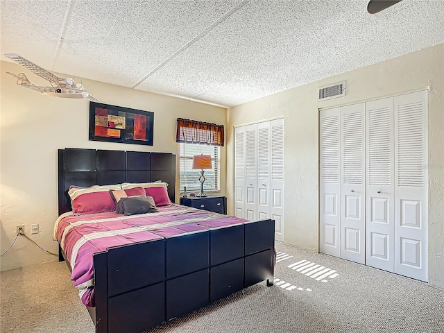 bedroom with carpet floors and two closets