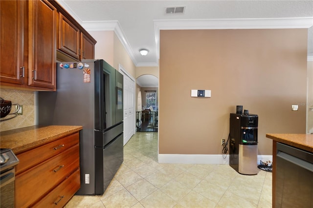 kitchen with tasteful backsplash, stove, refrigerator, light tile patterned floors, and ornamental molding