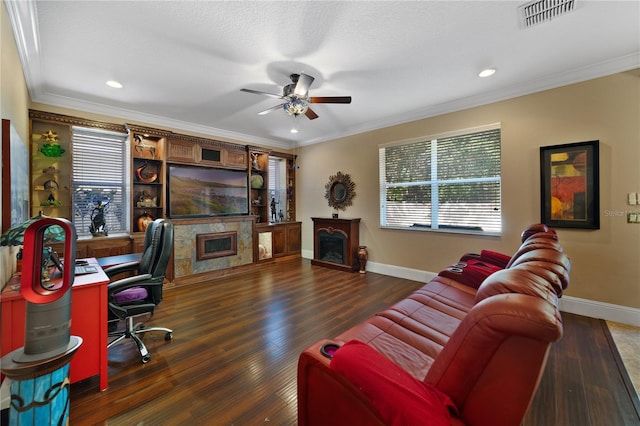 office space with ceiling fan, a fireplace, dark wood-type flooring, and ornamental molding