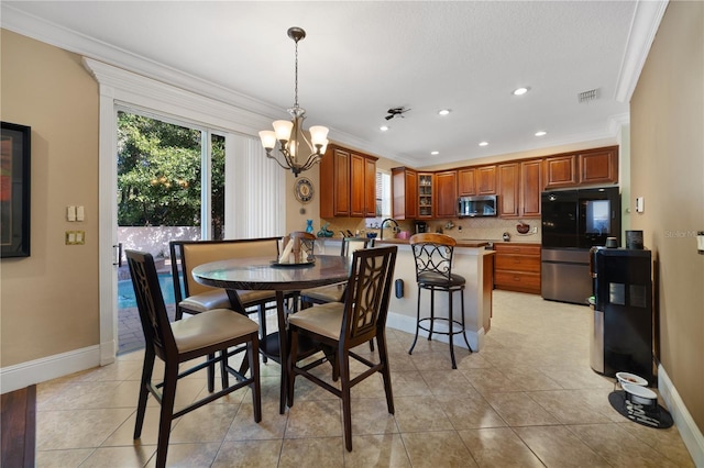 dining room featuring a notable chandelier, light tile patterned flooring, and ornamental molding