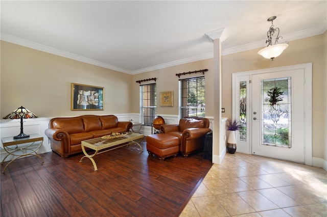 living room with light tile patterned floors and ornamental molding