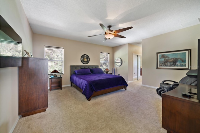 carpeted bedroom with multiple windows, a textured ceiling, and ceiling fan