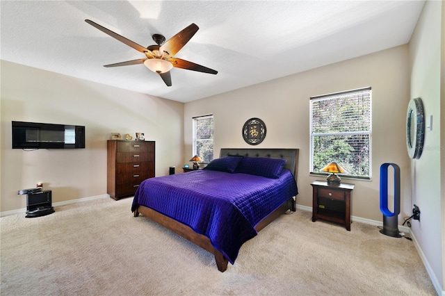 carpeted bedroom with a textured ceiling and ceiling fan