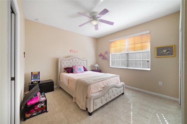 carpeted bedroom featuring a closet and ceiling fan