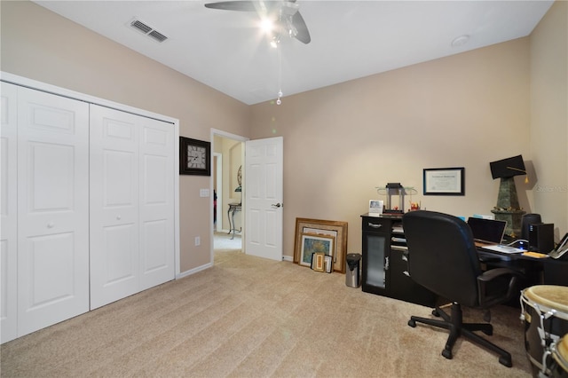 carpeted office featuring ceiling fan