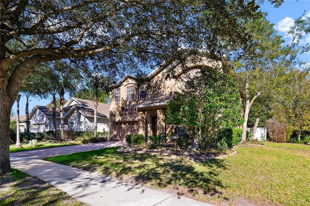 view of front of home with a garage and a front lawn