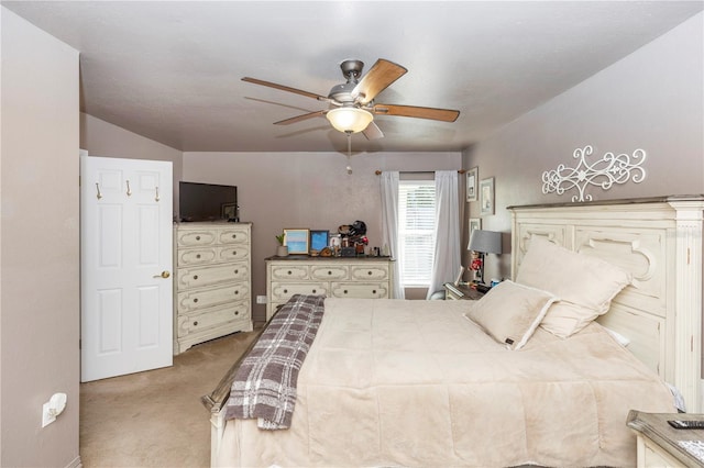 bedroom with ceiling fan and light carpet