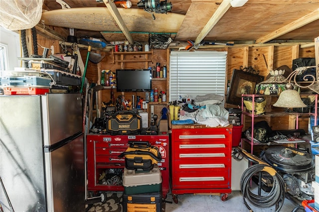 interior space with stainless steel refrigerator and a workshop area