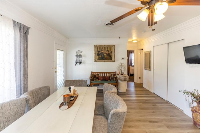 dining area with ceiling fan, ornamental molding, and hardwood / wood-style flooring