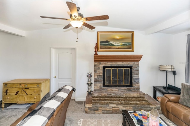 carpeted living room featuring ceiling fan, vaulted ceiling with beams, and a stone fireplace