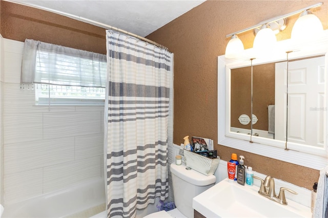 full bathroom featuring toilet, vanity, and shower / bathtub combination with curtain