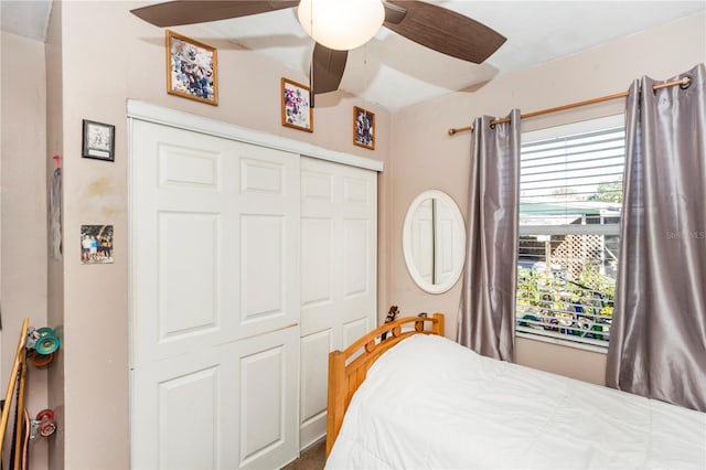 bedroom with ceiling fan and a closet