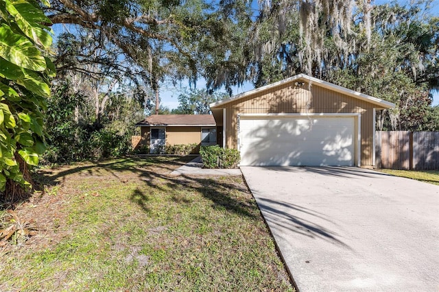 single story home with a front yard and a garage