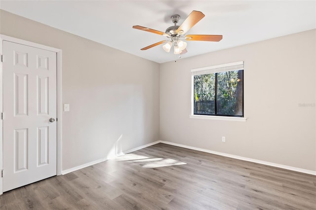 unfurnished room featuring hardwood / wood-style flooring and ceiling fan