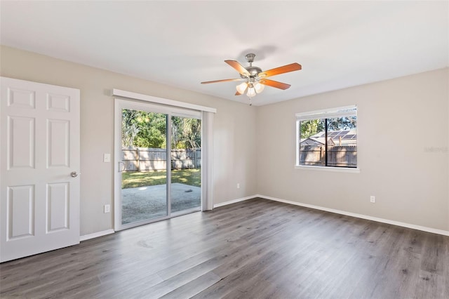 empty room with ceiling fan and dark wood-type flooring