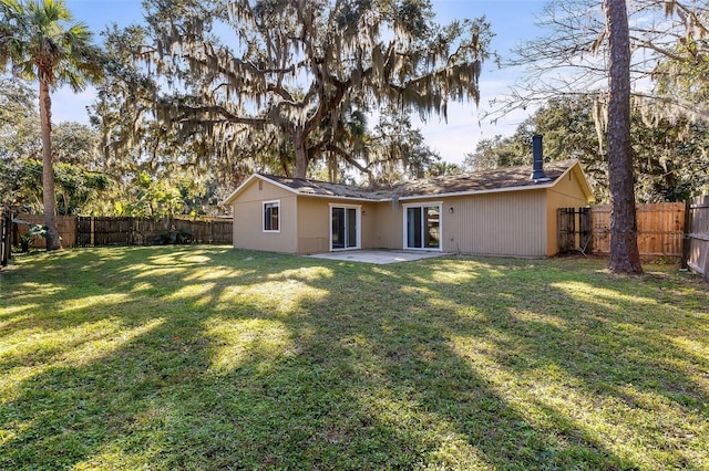 back of property featuring a patio area and a lawn