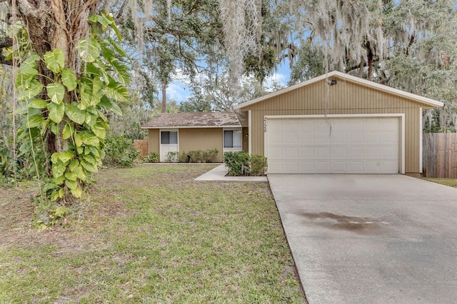 ranch-style home featuring a garage and a front yard